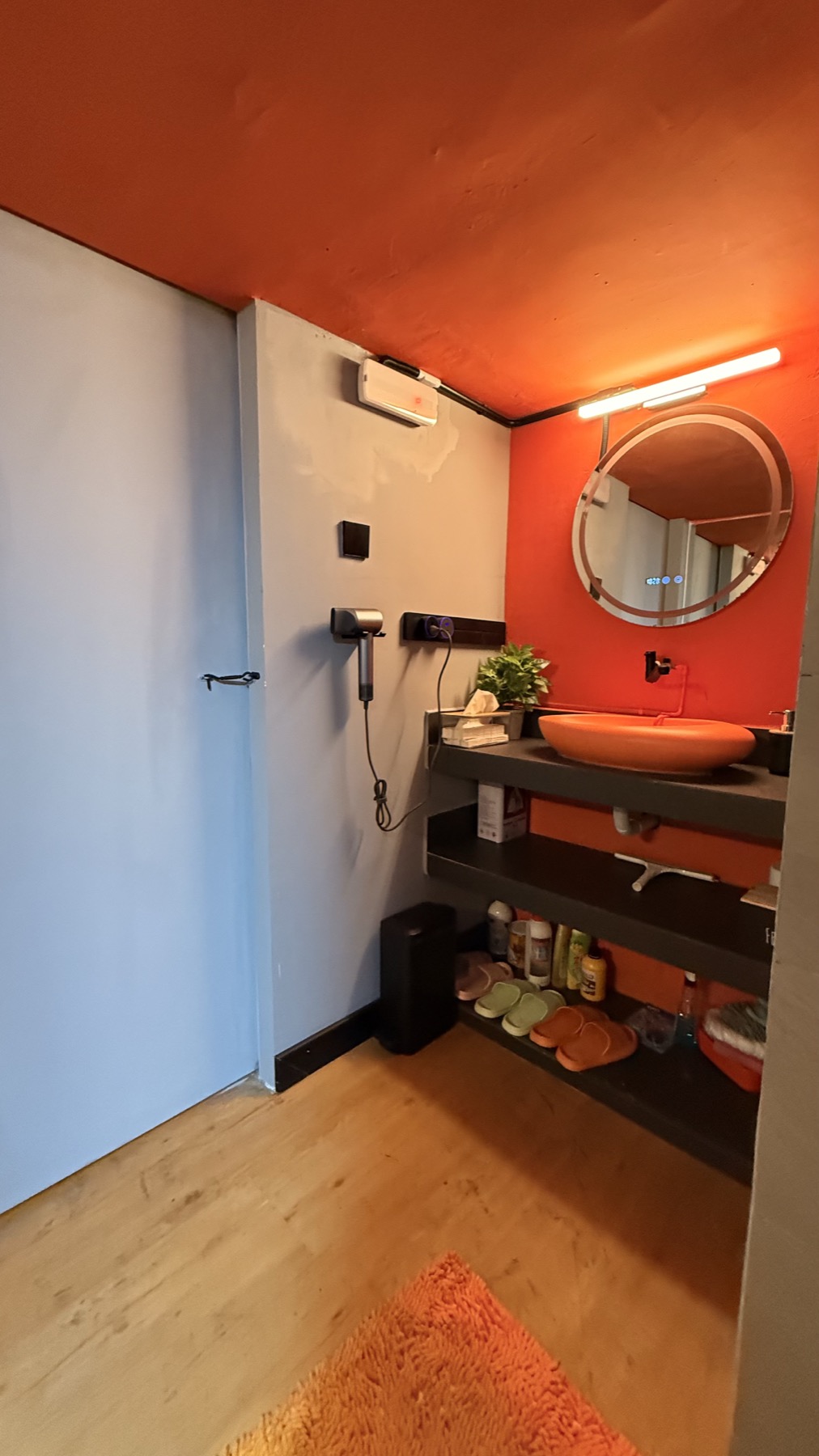 Toilet and changing area inside LEGACY+ with vanity and sink.