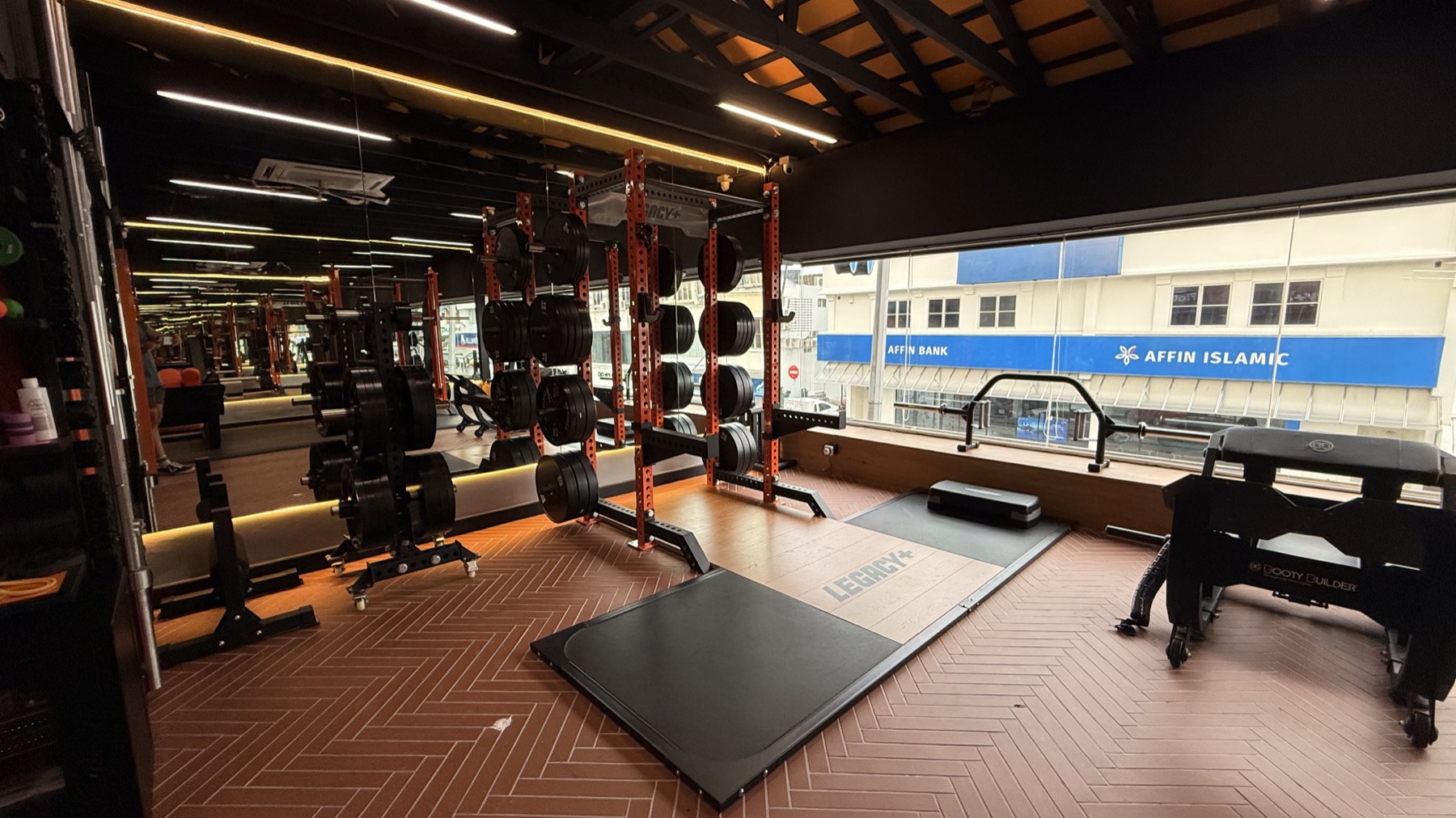 Training area at LEGACY+ with power rack, platform, and open coaching space.